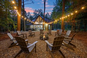 The fire pit surrounded by Adirondack chairs!