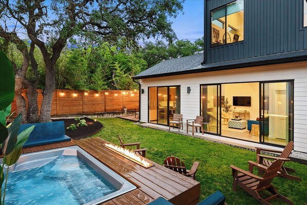 Outdoor area with pool, fire pit and enclosed yard space for privacy.