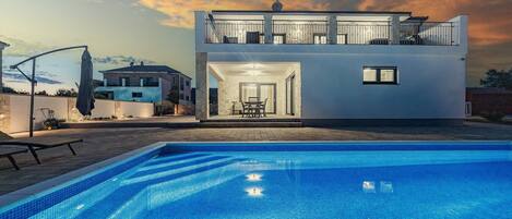 Property building and pool at night