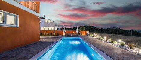 Property building and pool at night