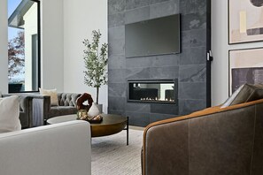 Cozy up by the modern fireplace in the living room, the perfect spot to unwind after a day of adventure. Enjoy the warmth and ambiance as you gather with loved ones, making memories that will last a lifetime.