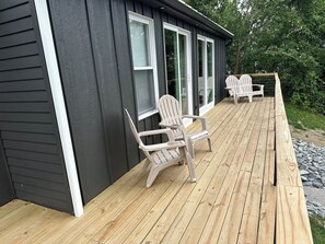 Back of the house features a deck the length of the cottage.