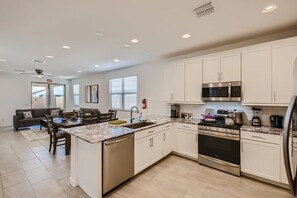 Enjoy the full kitchen and dining area with a refrigerator, freezer, oven, stove, microwave, dishwasher, coffee, creamers, mixers, spices, pots, pans, cooking supplies, cutlery, cups, plates, bowls, utensils, small appliances, and many more essentials.