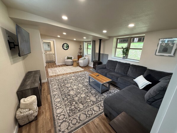 Big comfortable living room with 55” flat screen and gas fireplace