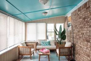 Sip a cold drink in the shade while still getting pool views in the sun room