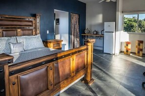 King size bed in upstairs bedroom and fridge