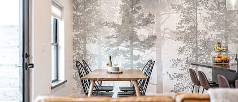 A unique forest-themed wallpaper backdrops the downstairs space.