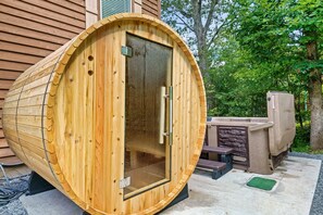 Daytime barrel sauna and hot tub.