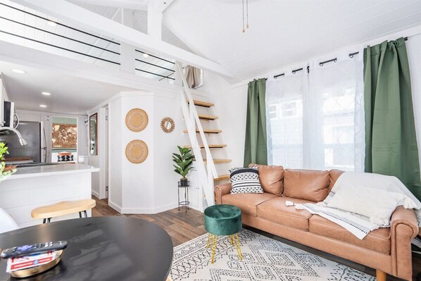Embark on a wanderlust journey in our bespoke travel-themed tiny home. Immerse in personalized charm and compact luxury as you explore the world in style.