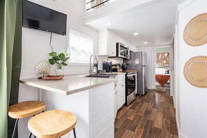 Embark on a wanderlust journey in our bespoke travel-themed tiny home. Immerse in personalized charm and compact luxury as you explore the world in style.
