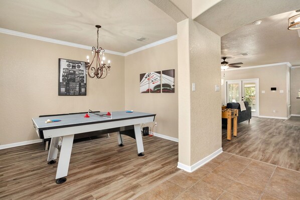 Air hockey table that converts to ping pong table.