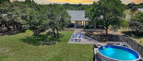 Aerial view of the backy yard showing fire pit and private pool.