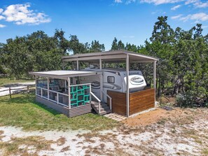 The Glamping Star RV with private deck and hot tub.