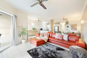  The spacious living area with pops of red colour and chic decorations will make you feel at home.
