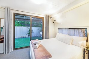 The bedroom also provides direct access to the backyard behind blackout curtains.