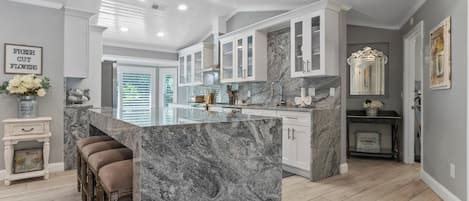 Kitchen with granite waterfall island and counter tops. 