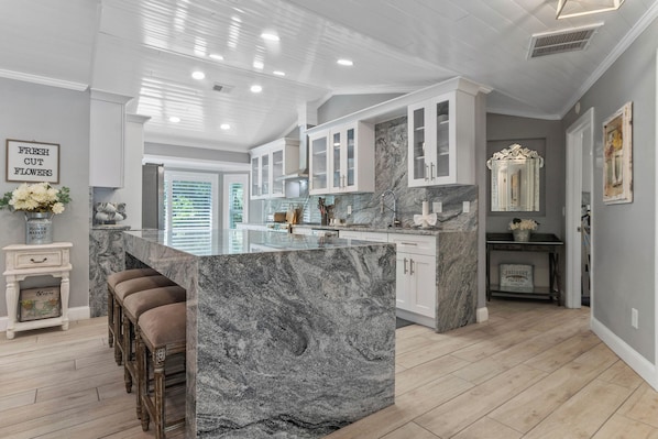 Kitchen with granite waterfall island and counter tops. 