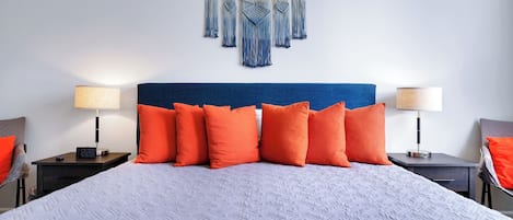 King bed in main bedroom with bright and wonderful colors to make your stay extra relaxing.