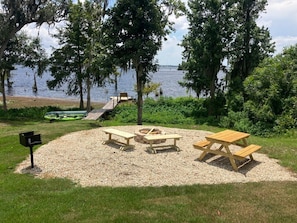 View from the front porch. Charcoal grille and firepit by the lake