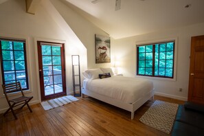 Cast Iron Guest House Queen Bedroom with Futon and Walkout Balcony.