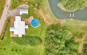 View of property with Pool and Pond