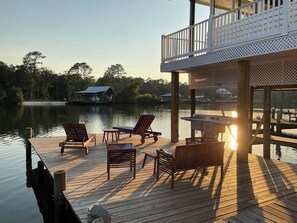 Sunset outdoor seating on Fish River.  Your own boat slip with lift. 