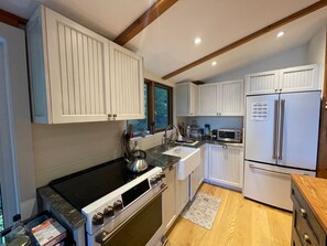 Fully equipped kitchen with stove, dishwasher, fridge and Nespresso coffeemaker.