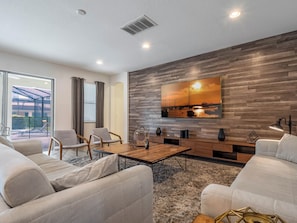 Spacious living area w/ pool views