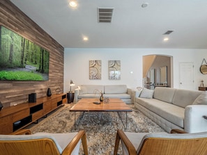 Spacious living area w/ pool views