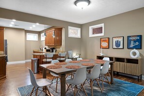 Dining area with table mats and spacious kitchen area 