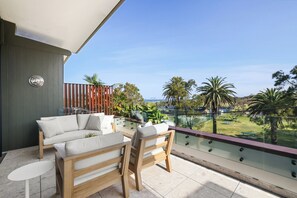 Large balcony with lounge area and separate outdoor dining area