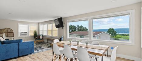 This 8-seat dining table is ideal for enjoying your meal while looking out the window with the view of Seneca lake.