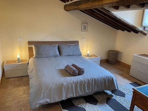 The first bedroom with king size bed, luxury mattress, and blackout shutters