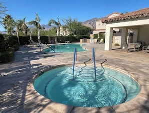 There is a hot tub in the shared pool space.