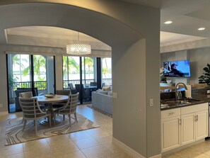 Open concept dining, living, and kitchen with view of the beach and lake Como!