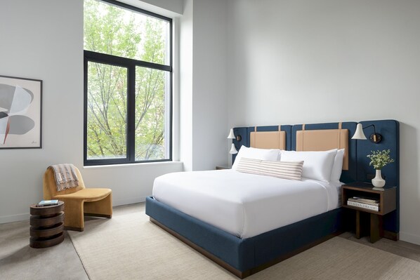 King Sized Bed, Premium linens, noise cancelling machine, armchair/footstool, bedside lamps, blackout shades. 