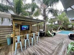 Tiki bar with smart TV is the perfect place to watch the game while grilling! 