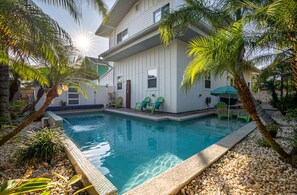 Captivating tropical landscape makes the back yard the perfect oasis hangout! 