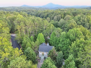 A secluded mountain retreat surrounded by lush greenery and breathtaking views—perfect for a peaceful escape in nature.