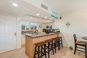 Another view of the kitchen and barstool seating. 