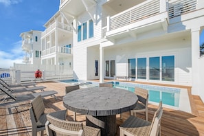 Pool area with pool loungers and table