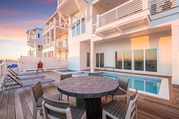 Pool area with lounge seats and tables for ultimate relaxation