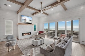Living room with TV and breathtaking beach view