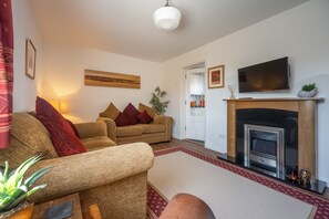 Escape, Aldeburgh: Sitting room with Smart television and electric fire