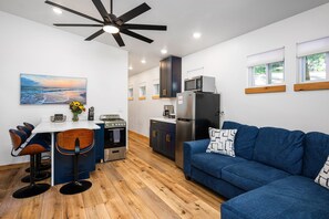 Enjoy light-filled moments in a stylish space with comfy seating and a functional kitchen!