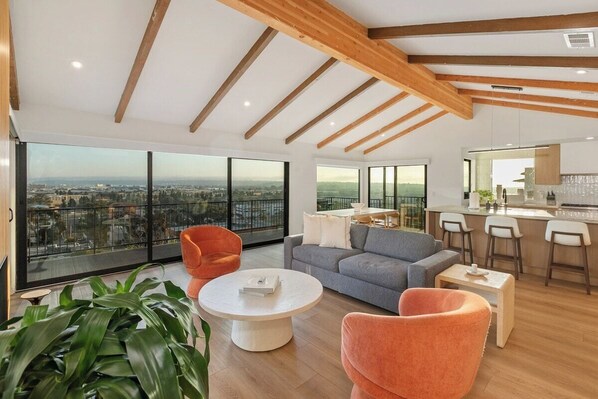 The great room, kitchen, and dining area with panoramic views of San Diego. 