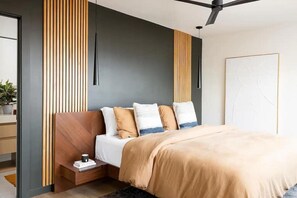 Primary king bedroom (main floor) - with en suite bathroom including balcony access overlooking the city.