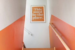 Inconspicuously tucked behind a small door in the lobby, this secret upstairs apartment will delight!