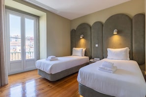 The third bedroom provides two single beds and balcony access. #comfort #apartment #lovely #bed #lisbon