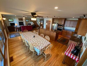 Lake-side dining table comfortably seats 12. Open to kitchen and living room.